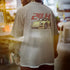 Person wearing a t-shirt with a car graphic and '24H' text on the back.